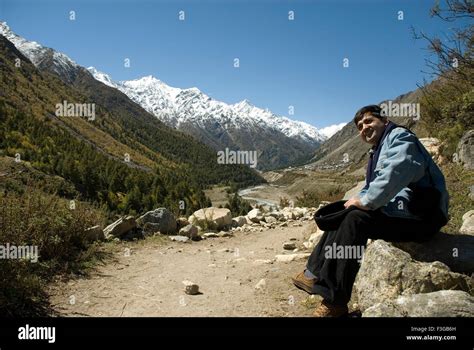 person watching chitkul valley snow covered mountains  sangla