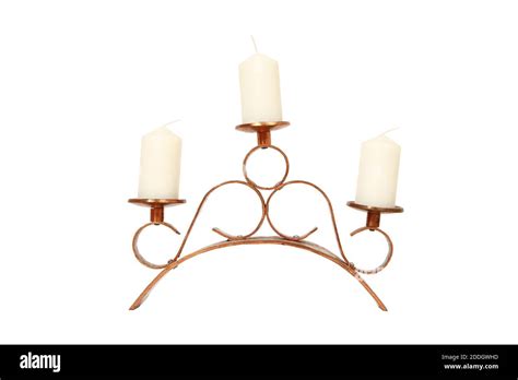 A decorative metal candle holder with three candles isolated on a white ...