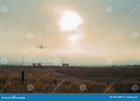 The Passenger Plane Landing At The Airport At Sunset Stock Image