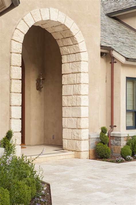 The stone arch compliments the travertine entry making for a refined