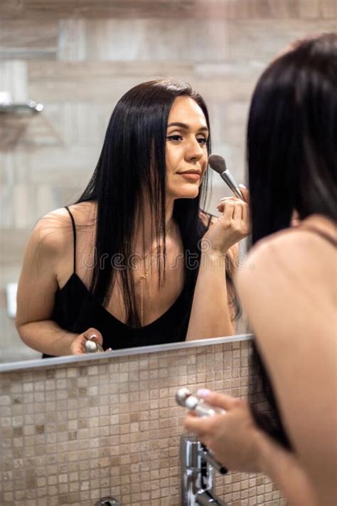 Happy Brunette Woman Applying Makeup Powder Blush Foundation Use Brush In Front Mirror At