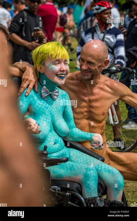 Naked Disabled Female In Green Body Paint In Crowd Participating In