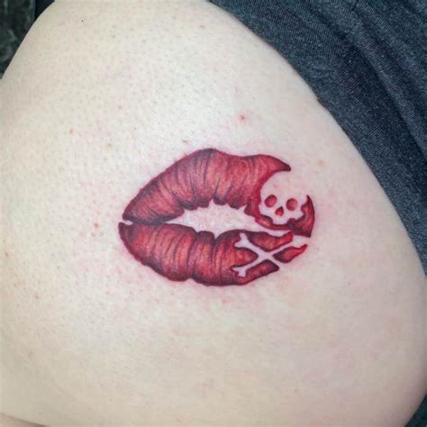 A Woman S Stomach With A Red Lipstick And Skull On It