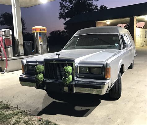 Neighbors watch as a vintage hearse drives through town 2