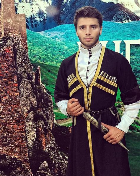 a man dressed in medieval clothing standing next to a sign with ...