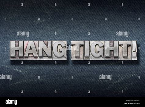 Hang Tight Phrase Made From Metallic Letterpress On Dark Jeans