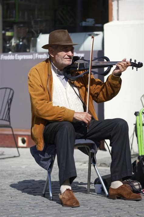 Man Playing Violin Sitting