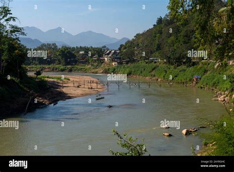 View Of A Bamboo Bridge Over The Nam Khan River In Luang Prabang In