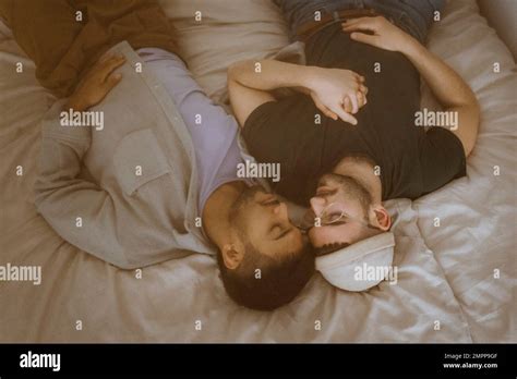 High Angle View Of Gay Couple Lying On Bed With Eyes Closed Resting At Home Stock Photo Alamy