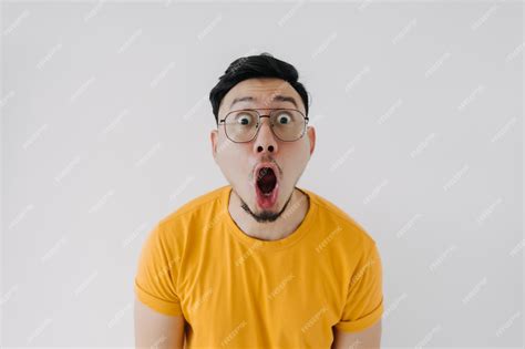 Premium Photo Shocked Surprised Face Asian Man Yellow Tshirt