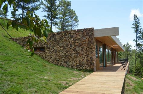 Grass Roofed Home Built Into Slope Uses Hillside For Cooling