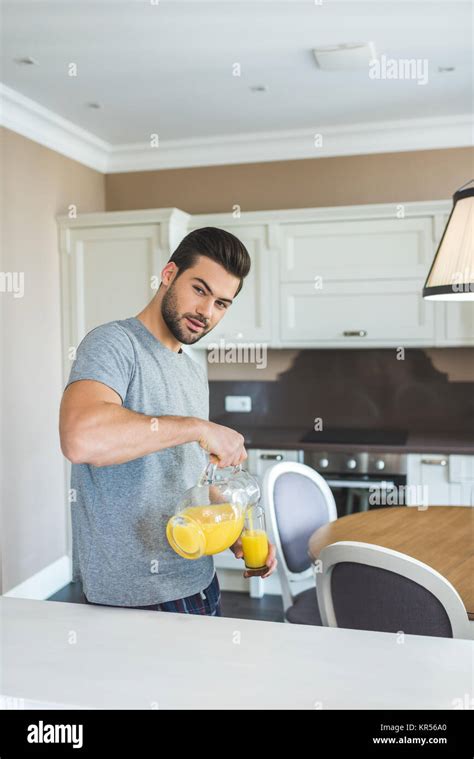 Man Pouring Orange Juice Stock Photo Alamy