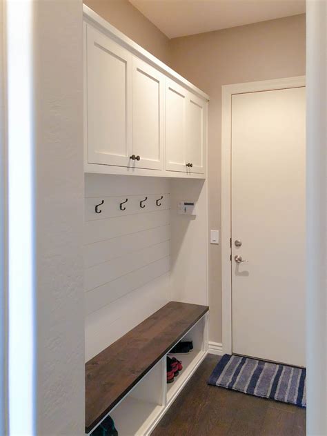white mud room cabinet unit  shiplap backing custom cabinetry
