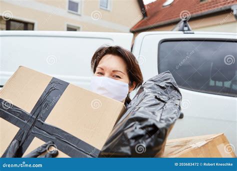 Delivery Service Parcel Carrier With Face Mask Carries Many Parcels