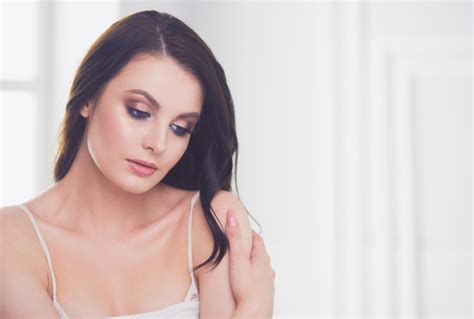 Premium Photo Beautiful Brunette Lying On Bed At Home