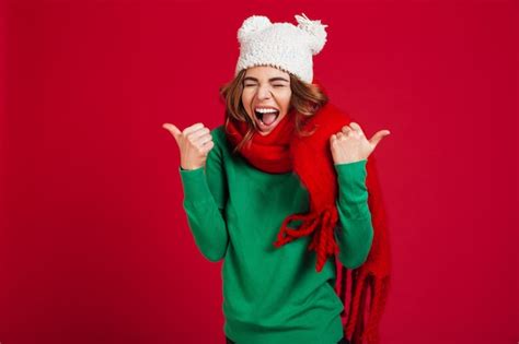 Free Photo Happy Screaming Brunette Woman In Sweater Funny Hat And Scarf