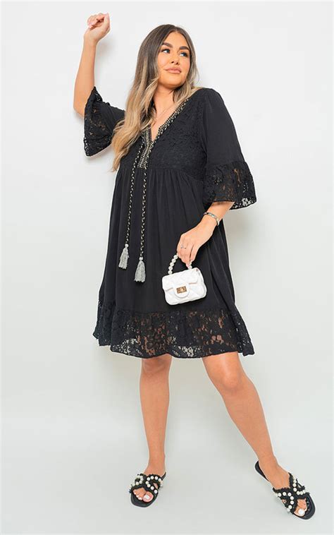 Bella V Neck Lace Pattern Mini Dress With Front Tassel Detail In Black