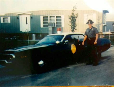 Kansas Highway Patrol trooper Leo Conners (K381) next to his 1971 ...