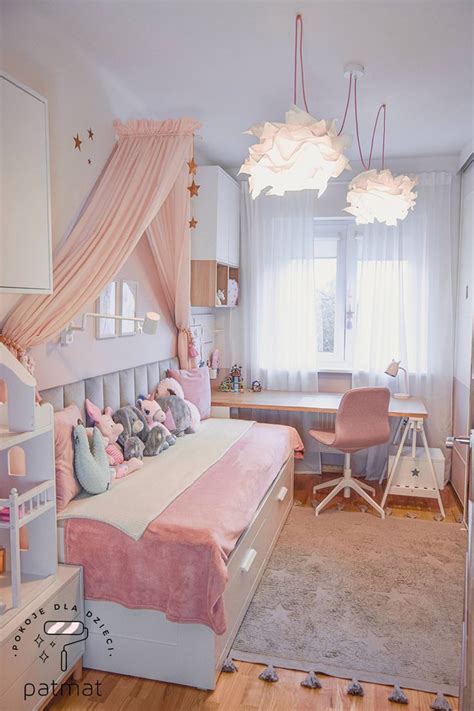 A Bedroom With Pink And White Decor In It