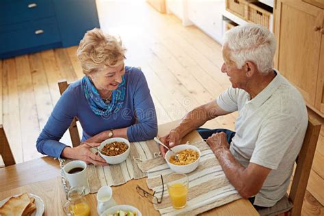 Breakfast With A Generous Serving Of Love A Happy Mature Couple Having Breakfast Together In