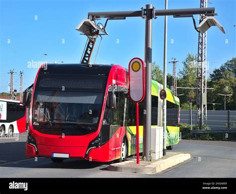 Electrical Bus Recharging At An Overhead Charging Bus Stop Stock Photo