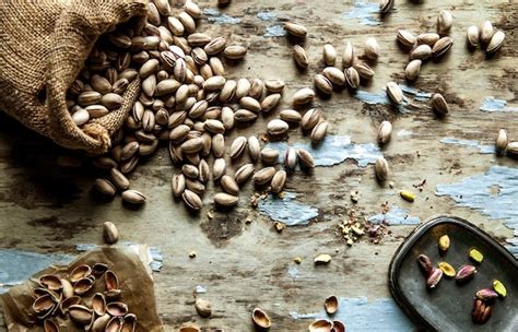 Premium Photo Roasted Pistachios On Natural Wooden Table Background