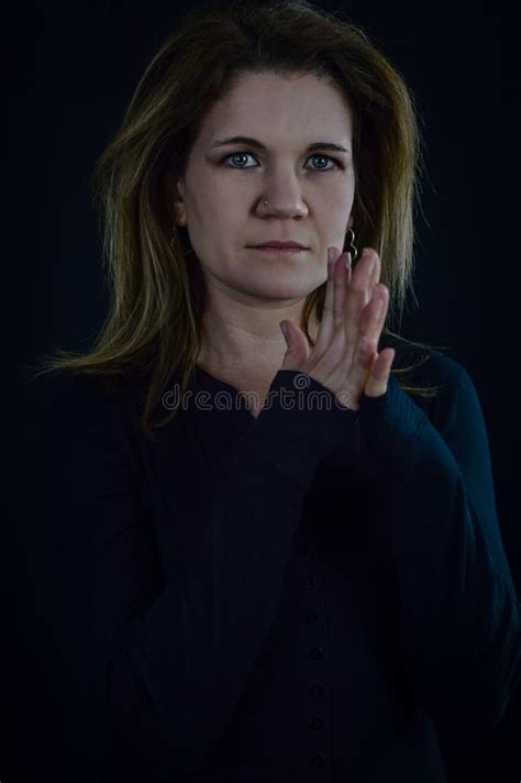 Portrait Of A Beautiful Elegant Blonde Woman With Fingers Intertwined As If In Prayer Stock