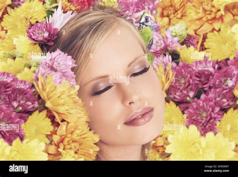 Feeling Floral A Young Woman Posing With Her Eyes Shut And Flowers In