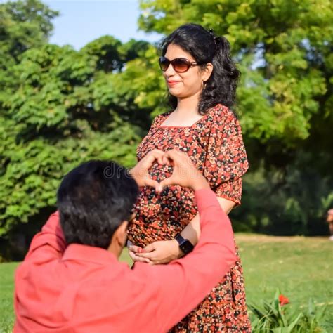 Indian Couple Posing For Maternity Shoot Pose For Welcoming New Born