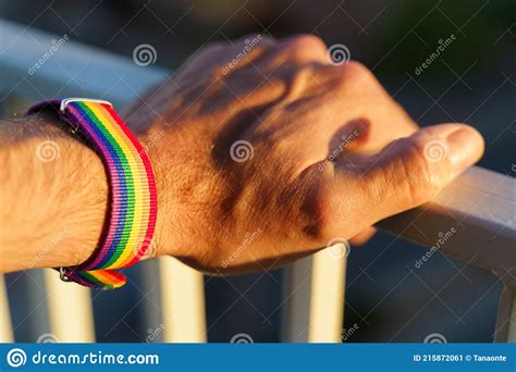 Close Up View Of A Manand X27 S Hand With An Lgbt Rainbow Wristband