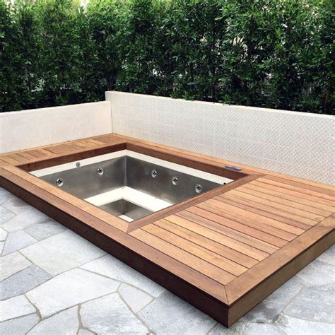 A Hot Tub Sitting On Top Of A Wooden Deck