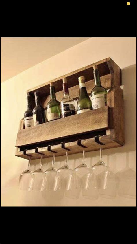 Wine Glasses And Bottles Are Lined Up On A Wooden Shelf Above The Wine