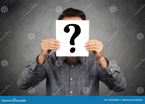 Mysterious Man With Question Mark Card Over Face Denotes Anonymity