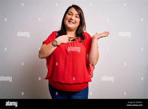 Beautiful Brunette Plus Size Woman Wearing Casual Red T Shirt Over Isolated White Background