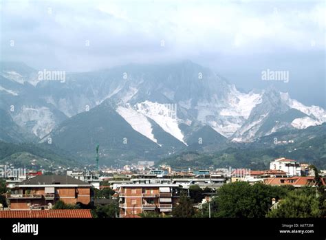 Residential Areas Below A Summer View Of White Quarry Workings In Apuan