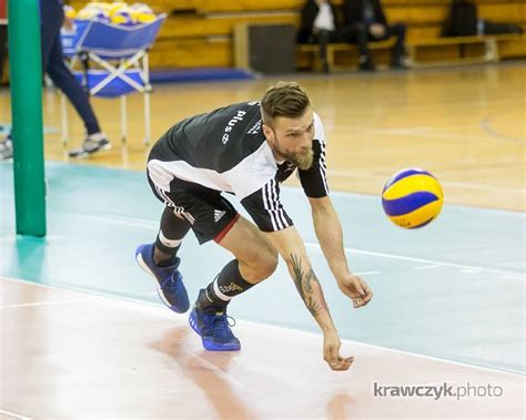 A Man In Black And White Shirt Playing Volleyball