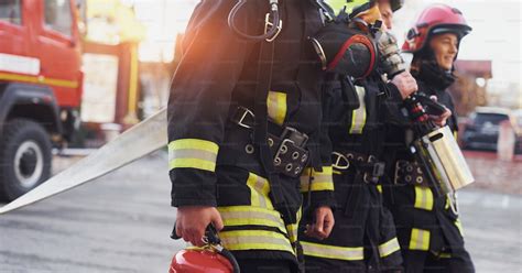 Group of firefighters in protective uniform that is on station. photo ...