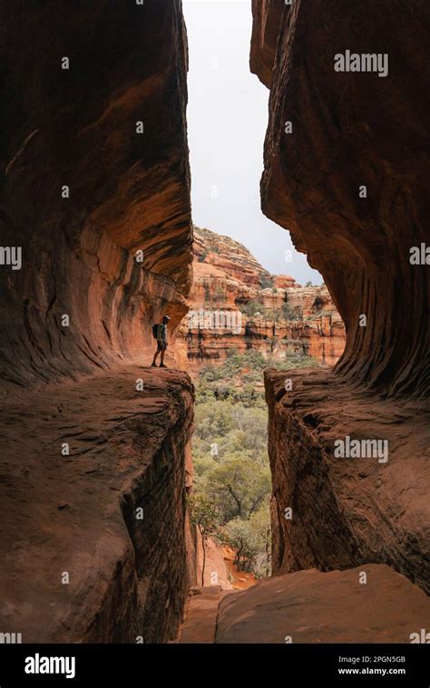 Young Man Hiker Stands In Subway Cave In Boynton Canyon Sedona Arizona