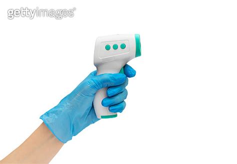 Hand In Blue Medical Glove Holding Electronic Infrared Thermometer