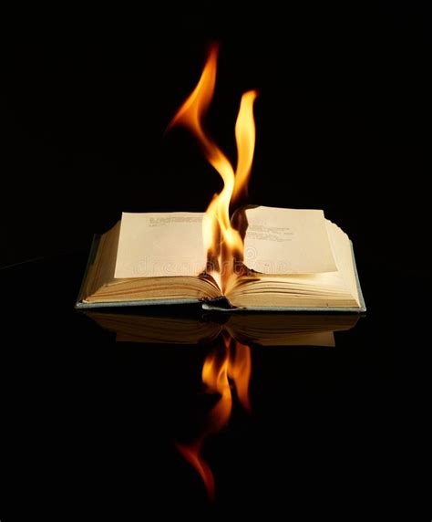 Burning Book On Black Background And Reflective Surface Concept