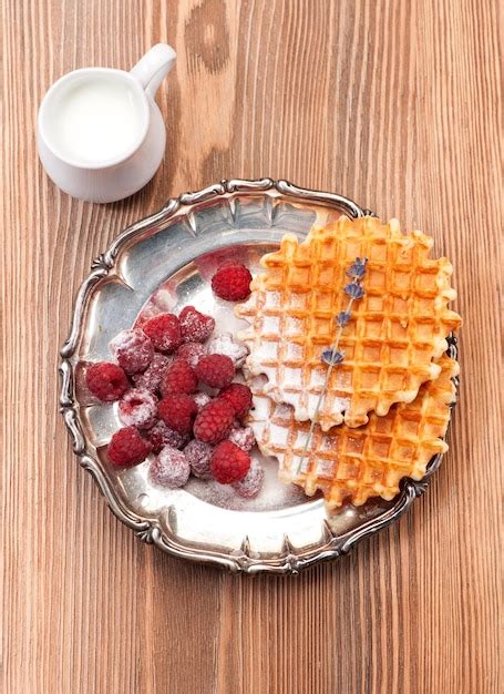 Premium Photo Belgian Waffles With Raspberry And Milk On Vintage Plate