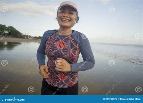Fit And Attractive Mature Woman With Grey Hair Doing Beach Workout On Her S Running On The