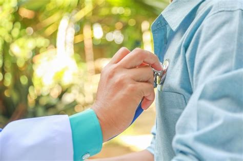 Premium Photo Cropped Hand Of Doctor Examining Male Patient In Hospital