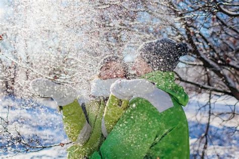 Premium Photo | Couple in love throwing snow and hugging in winter forest young people having fun