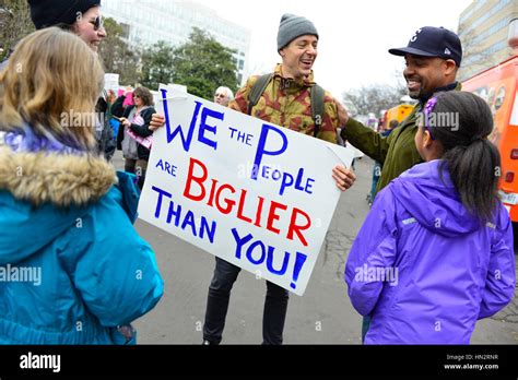 Large Crowd Of Protesters Many Wearing Pink Pussy Hats Holding Anti Trump Policy Signs In