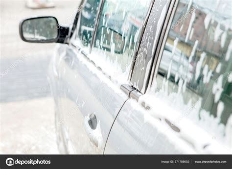 Car wash with foam in car wash station. Carwash. Washing machine at the station. Car washing ...