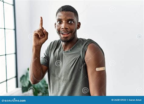 Young African American Man Getting Vaccine Showing Arm With Band Aid