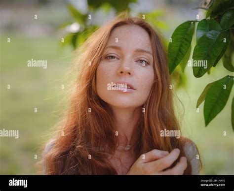 Beauty Woman Face With Healthy Skin And Green Plant At Sunset Time Outdoor Healthy Lifestyle