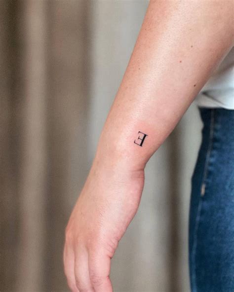 Minimalistic Tattoo Of The Letter E Located On The