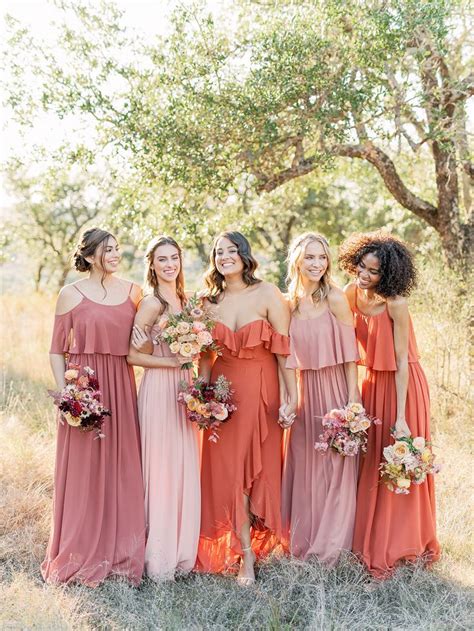 The Bridesmaids Are All Wearing Different Colored Dresses